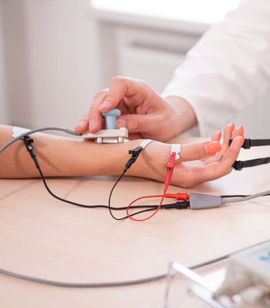 Un médecin qui fait un électromyogramme à un patient